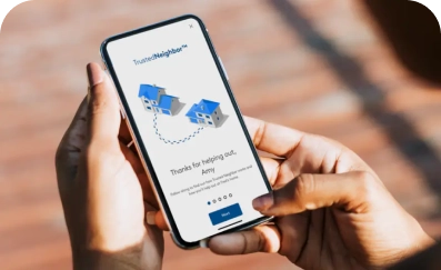 Hand holding phone displaying ADT+ app